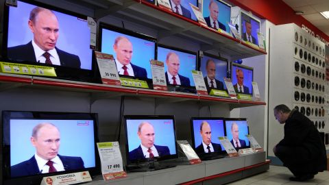 TV screens show Prime Minister Vladimir Putin's annual phone-in session with Russians in Moscow.