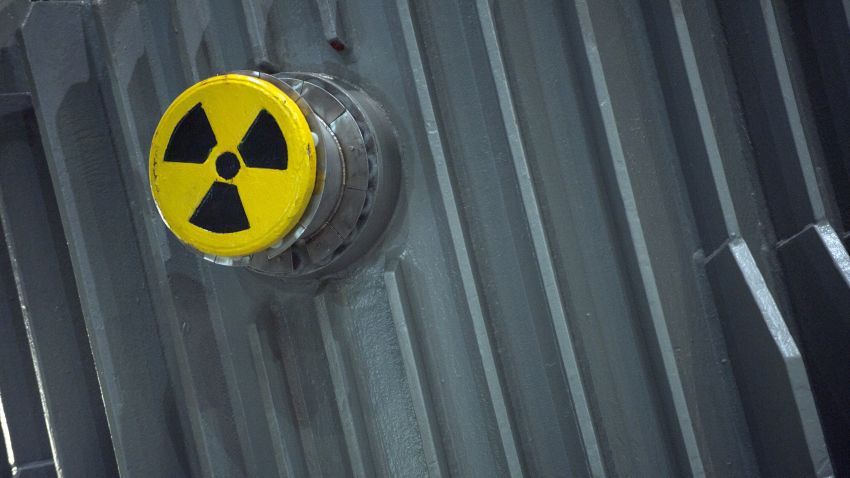 A picture taken on November 22, 2011 shows a radioactivity warning symbol on a 'CASTOR' (Cask for Storage and Transportation of Radioactive Material) container carrying highly radioactive nuclear waste which is part of a convoy waiting at the Areva's train station in Valognes, northwestern France, a day before leaving for Gorleben in Germany. Despite massive police forces deployment, anti-nuclear protests are expected in France and Germany against the transport of the eleven so-called 'CASTORS' containing nuclear waste. AFP PHOTO / KENZO TRIBOUILLARD (Photo credit should read KENZO TRIBOUILLARD/AFP/Getty Images)