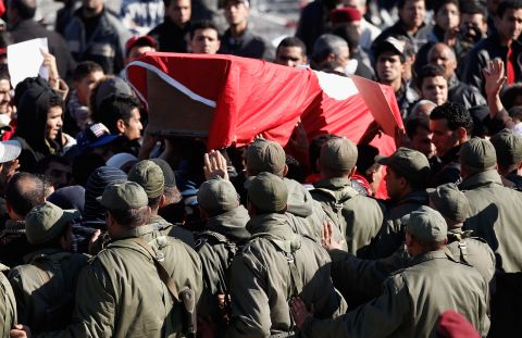 Protesters carry a coffin draped in the Tunisian flag representing martyr Mohamed Bouazizi on January 24, 2011 in Tunis, Tunisia. 