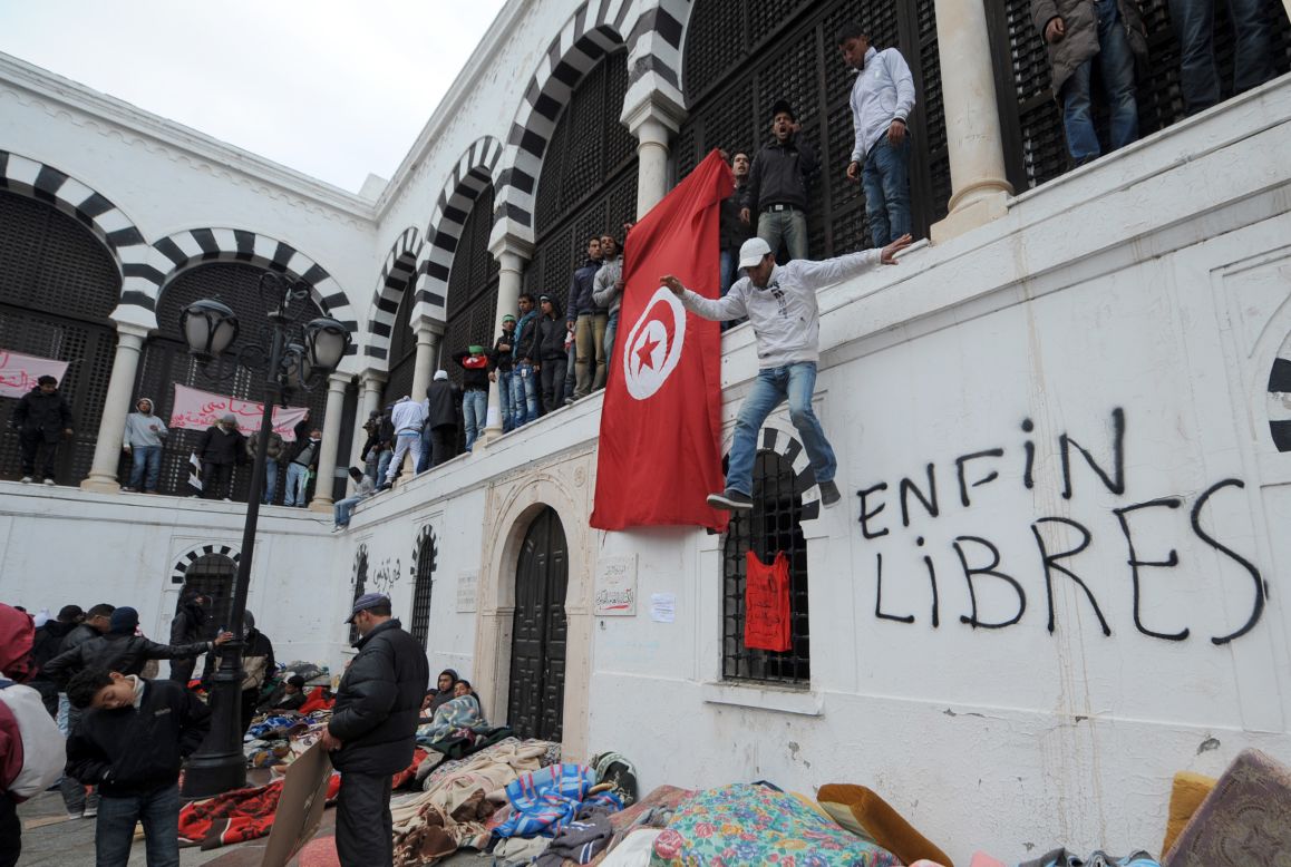 Inhabitants of the central Tunisia region of Sidi Bouzid who slept overnight near the office of the Tunisian Prime Minister in Tunis on January 24, 2011 call for the government to resign. 