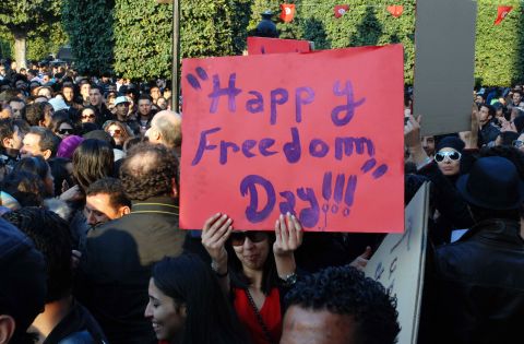 Tunisians hold banners during a rally on February 14, 2011 in Tunis on Valentine's Day celebrating a month of freedom. 