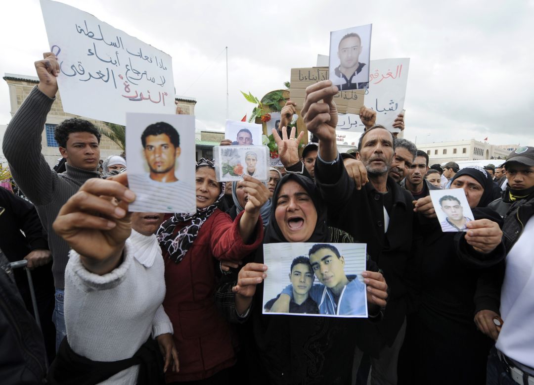 Tunisians show pictures of relatives who died during the revolution at a rally on March 19, 2011 in Tunis.
