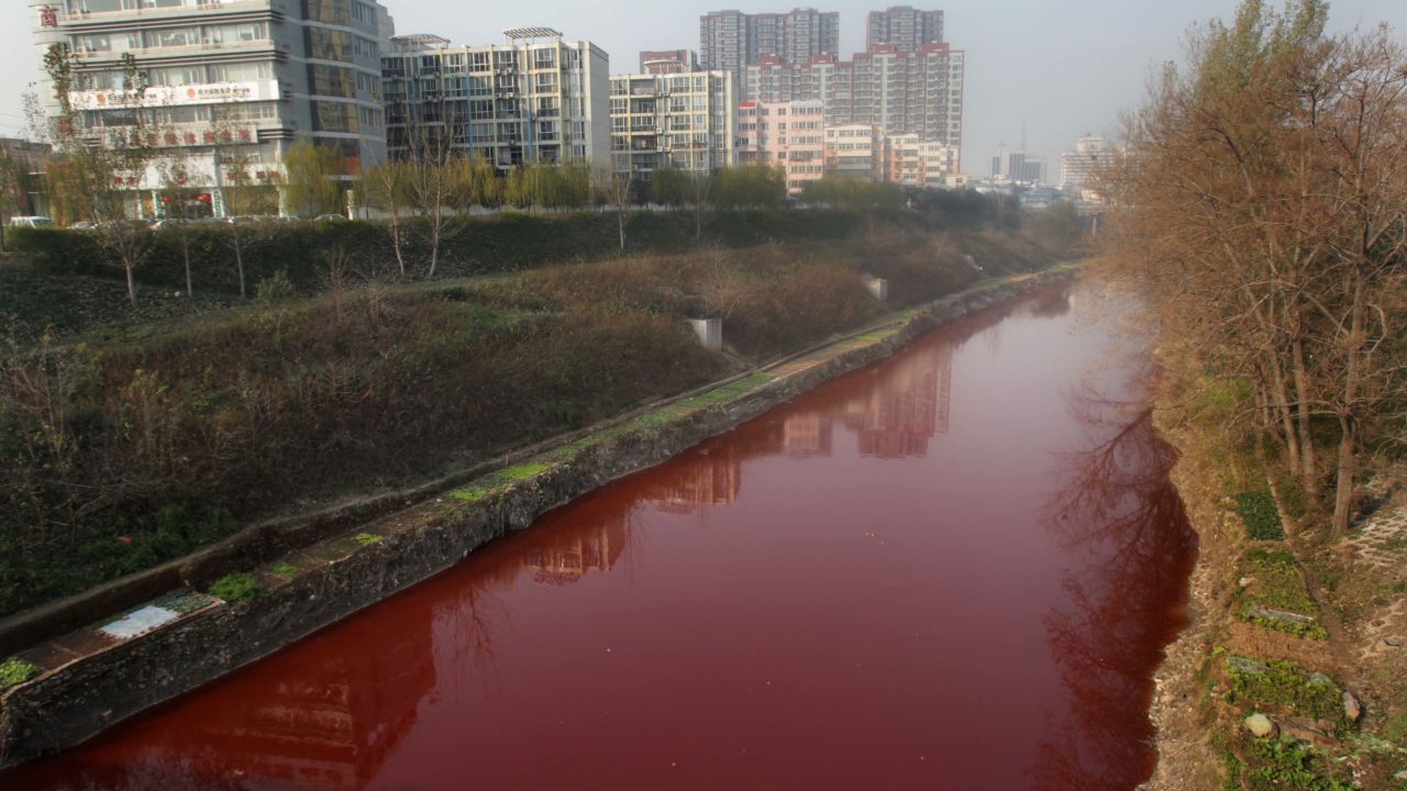 The Jian River flows red after being polluted with dye from an illegal workshop.