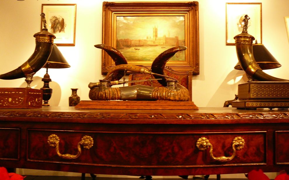 This dresser included Victorian horn ink and desk set (center) and a pair of continental lidded horn vessels with silver mounted figural lids, both expected to bring in between $300 -$500. The Maitland-Smith Chippendale style partners desk upon which they items were situated was priced at $2,000 - $4,000.