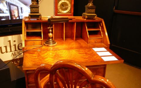 Another featured item was this federal style secretary desk with highly figured polished wood. It was expected to bring in between $800 - $1,200.