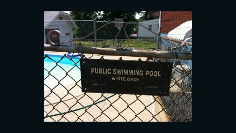 Michael Gunn says he tried to keep his bi-racial daughter from hearing about the sign that appeared after she swam at a pool.