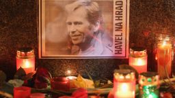 A portrait of former Czech President Vaclav Havel, with a text that reads: 'Havel To The Castle,' a popular slogan during the Velvet Revolution of 1989, lies among candles left by mourners at the base of a statue of St. Wenceslas to commemorate Havel's death on December 18, 2011 in Prague, Czech Republic.