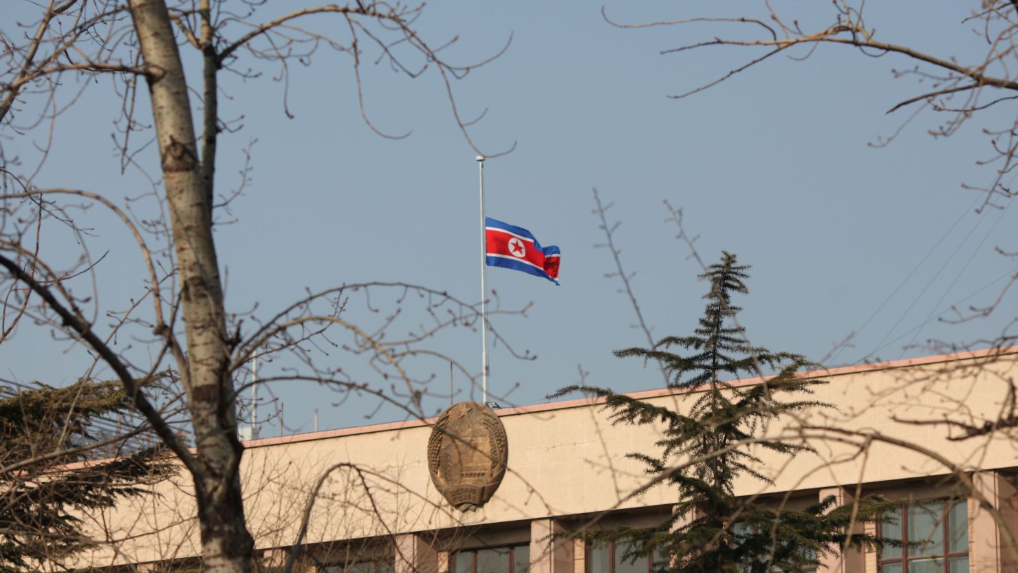 The North Korean flag flies at half-mast above the North Korean embassy in Beijing on December 19, 2011.
