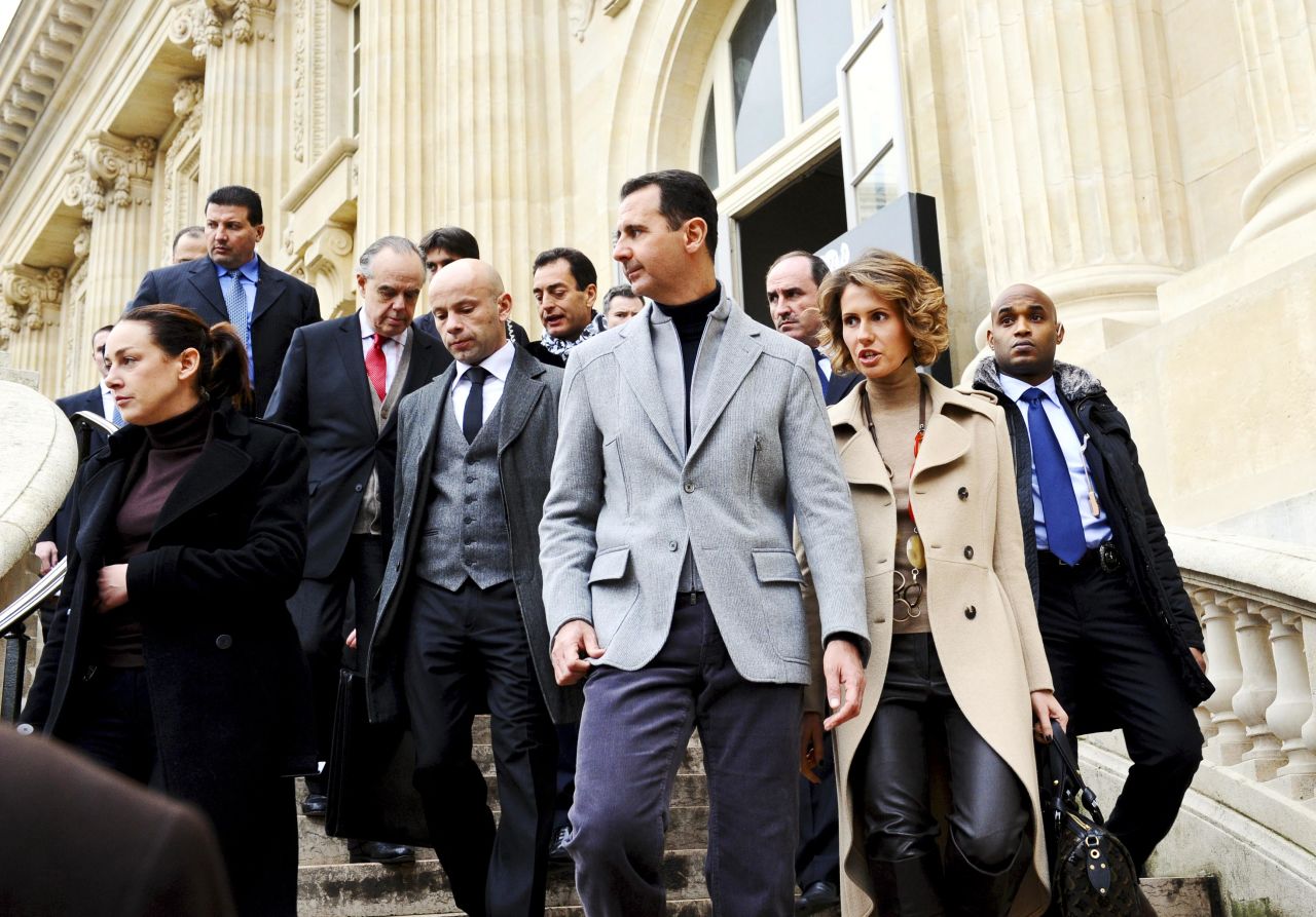 Bashar al-Assad and  Asma al-Assad depart the Claude Monet exhibition in December 2010 in Paris.