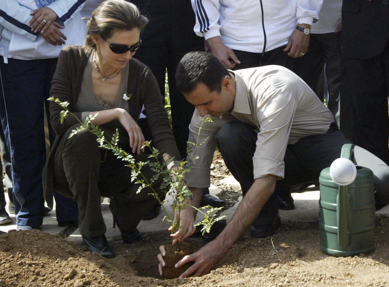 The Syrian first couple plant a jasmine bush in old Damascus in Syria in April 2007.