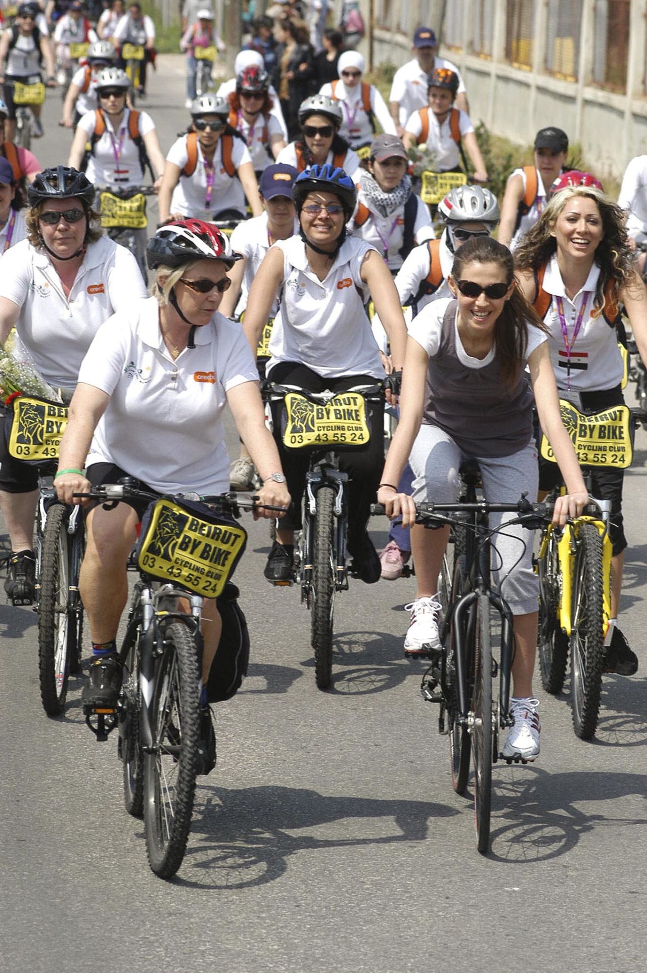 In a ride for peace, Asma al-Assad, right, leads a pack of female bicyclists in the Ras Shamra area of Latakia in Syria on April 8, 2007.