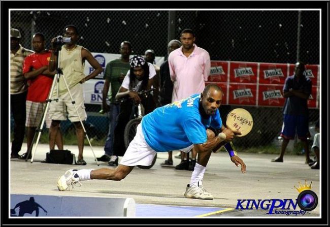 World champion White bends low to play a backhand return in match action. 