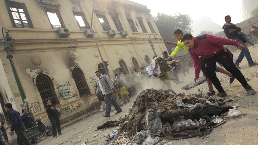 Protesters gather debris near the Institute of Egypt, which was torched during protests, in Cairo on December 20.