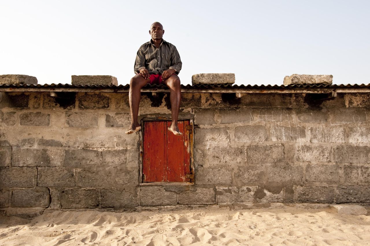 "Climate change" is a work by Nyani Quarmyne, who is based in Ghana. It shows a resident of a Ghanaian fishing village sitting on top of his home, which is rapidly disappearing beneath the sand as the sea encroaches on the village.   