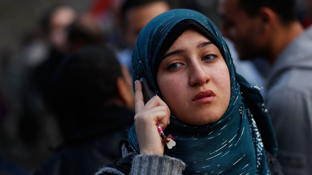 A woman talks on a mobile phone in Cairo's Tahrir Square on February 12, 2011.
