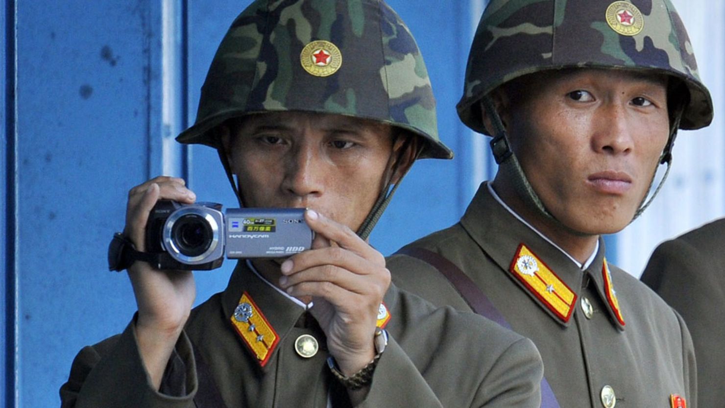 North Korean soldiers look and film footage of the south side of the demilitarized zone in September 2011.