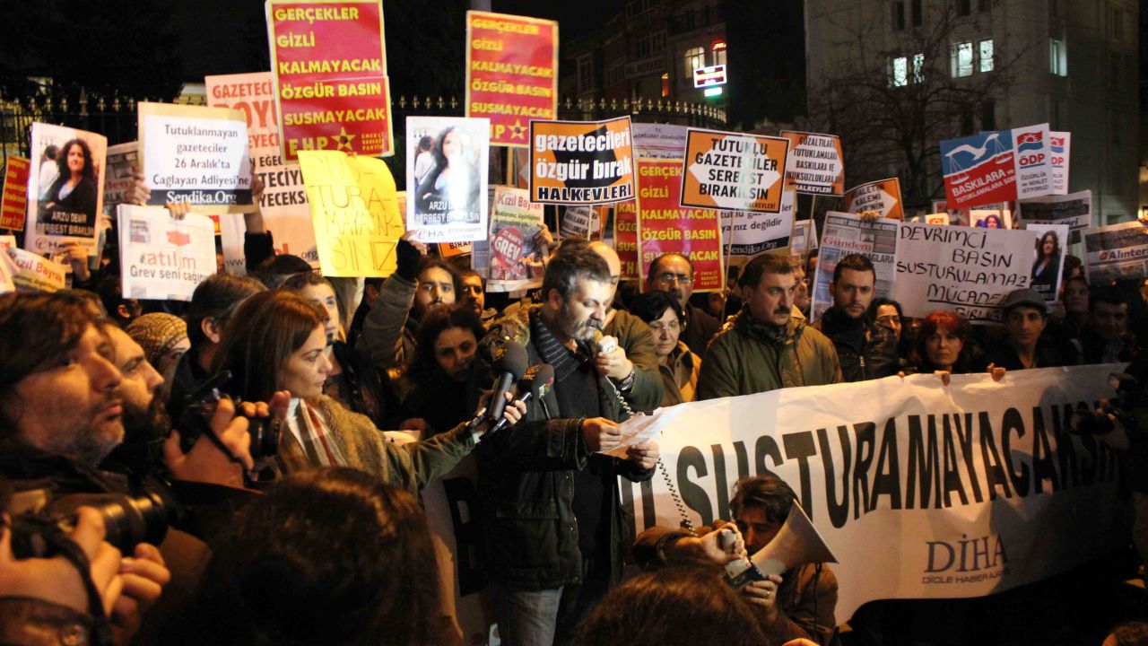 Journalists and human rights activists gather in Istanbul on Tuesday to protest the detention of dozens of journalists.