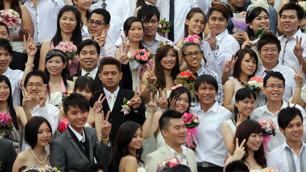 Newlywed couples pose for photographs during a mass wedding ceremony at the Thean Hou temple in Kuala Lumpur on November 11, 2011. 
