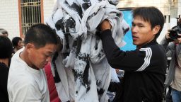 Villagers remove protest banners from the main street in Wukan, Guangdong Province on December 21, 2011