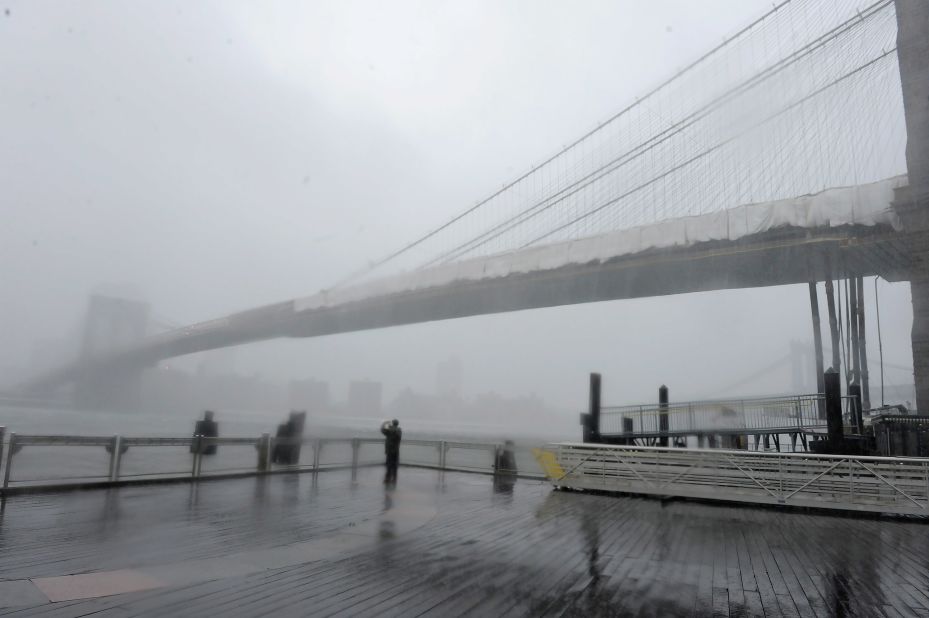Brooklyn Bridge stands shrouded in heavy rain and dark clouds as Hurricane Irene reaches the New York City area on August 28, 2011. According to Jan Corfee-Morlot, senior climate change analyst for the OECD, many developed coastal cities around the world face a "severe risk" of floods in the coming years.