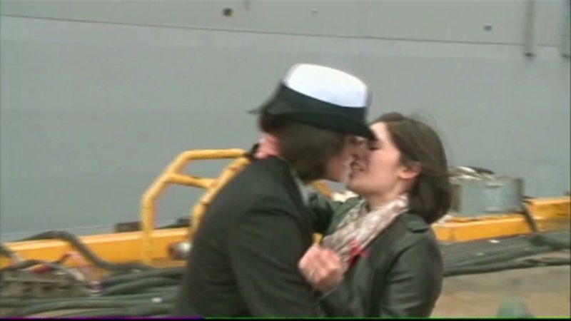Two women kiss at Navy homecoming photo picture