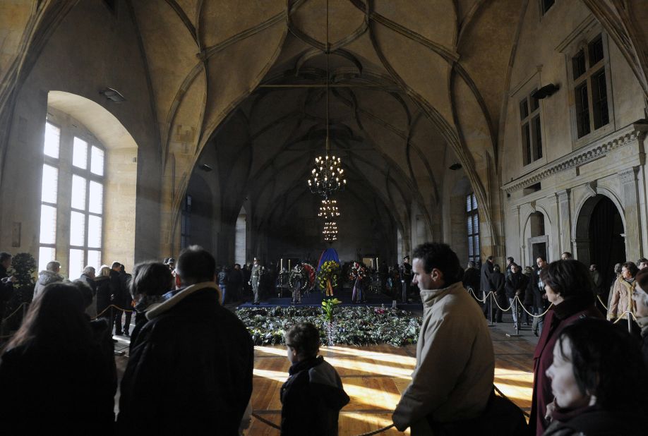 People line up in the Vladislav Hall at Prague Castle as they wait to pass by the former leader's coffin 