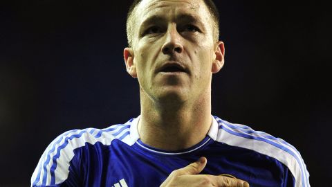 Chelsea captain John Terry touched the club badge as he saluted fans after the 1-1 draw at Tottenham. 