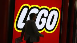 A  fair-goer walks past the logo of Danish toy maker Lego 01 February 2007 at the International Toy Fair in Nuremberg, southern Germany