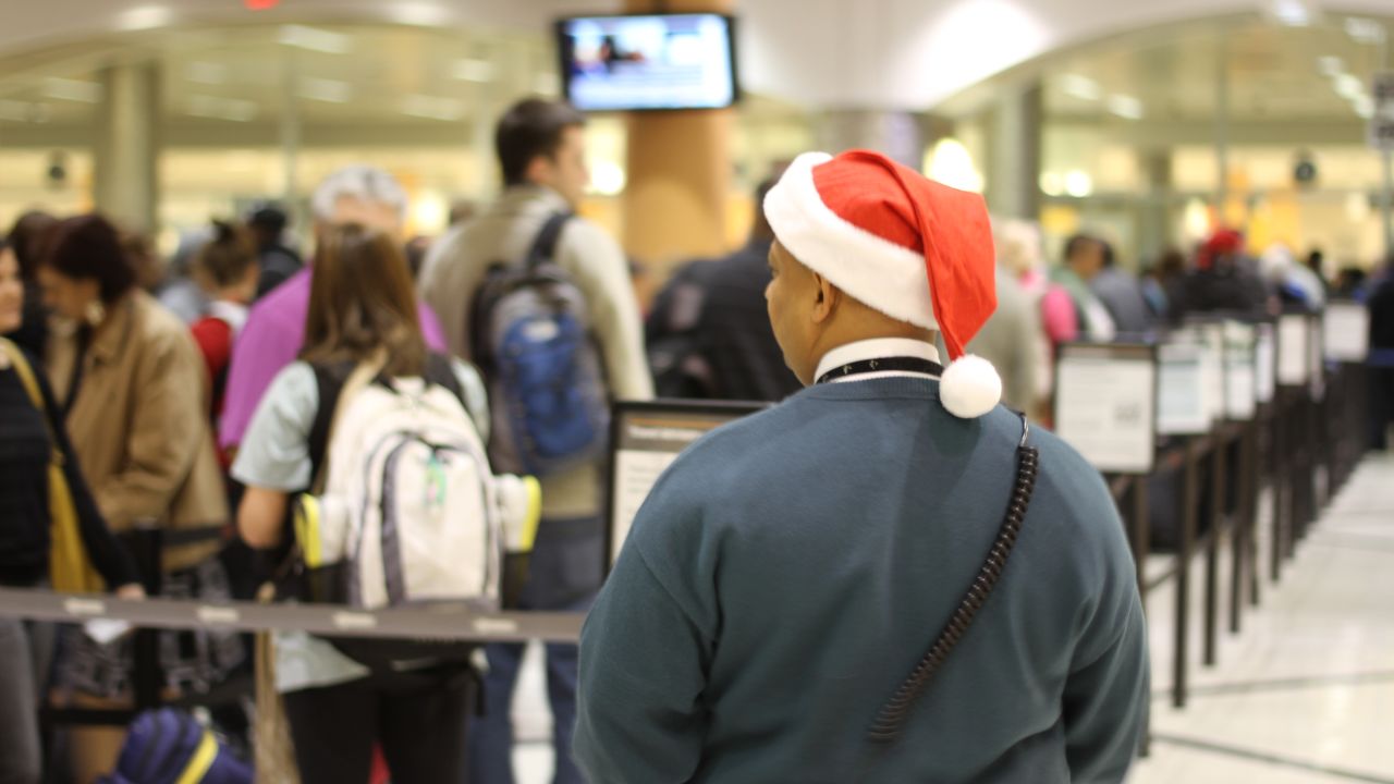 Travelers move through security lines Friday at  Atlanta's Hartsfield-Jackson International Airport. 