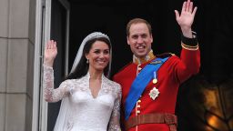 Britain's Prince William and his wife Catherine, Duchess of Cambridge, wave to the crowd from the balcony of Buckingham Palace in London on April 29, 2011, following their wedding.
