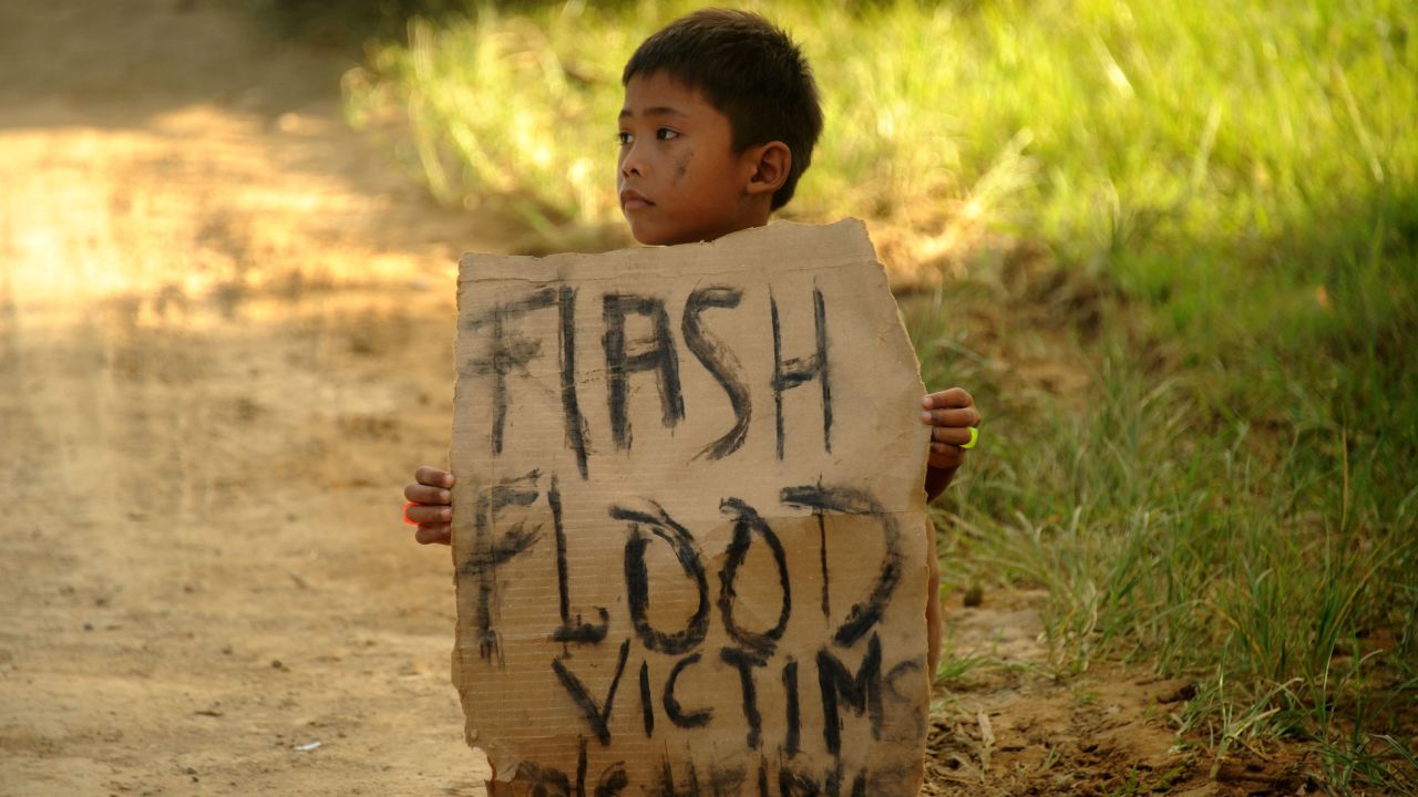 A boy holds a placard on a street in Cagayan de Oro on December 24, 2011. 
