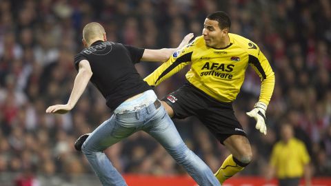 AZ Alkmaar goalkeeper Esteban Alvarado lashes out at a fan who attacked him in their Dutch Cup tie against  Ajax.