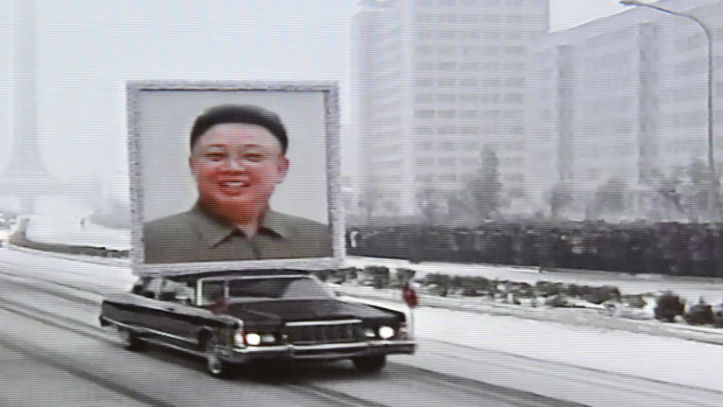 This TV grab taken from North Korean TV December 28 shows a car in Pyongyang with a portrait of the late leader Kim Jong Il.