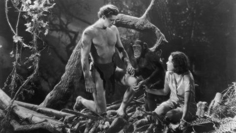Johnny Weissmuller and Maureen O'Sullivan hold hands with Cheetah the chimpanzee in "Tarzan and His Mate."
