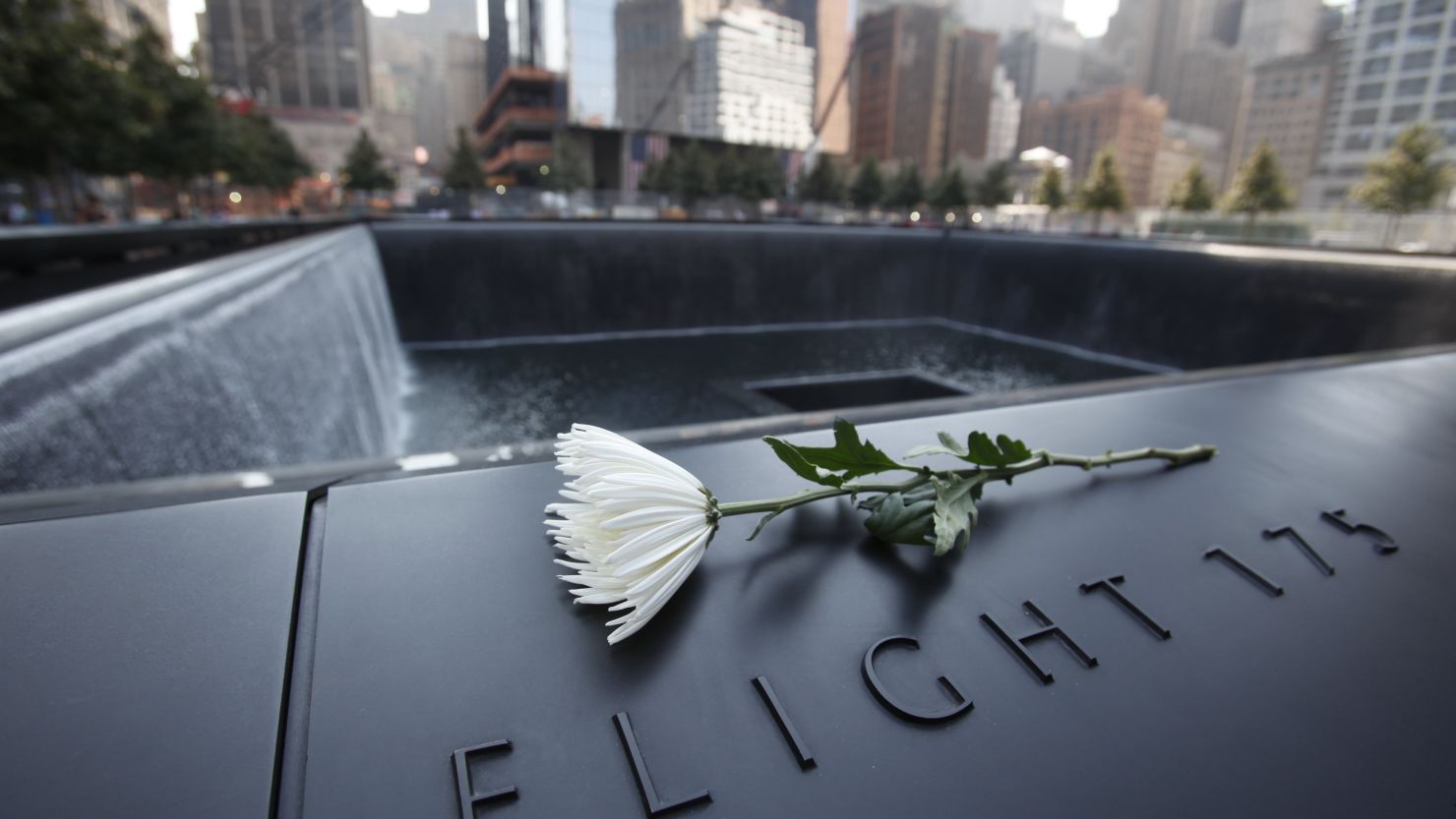 A flower sits on one of the panels containing names of the victims of the terrorist attacks from September 11, 2001, at the 9/11 Memorial.