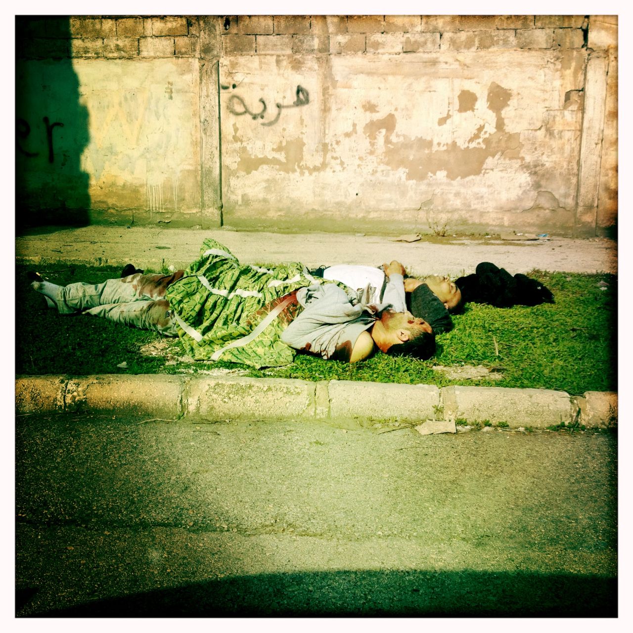 Unidentified bodies lie on Brazil Street, bordering the Baba Amr neighborhood in Homs, Syria. Regime activists say the regime kidnapped, tortured and killed these men and threw their bodies onto the street.  Any attempt at recovery was made impossible because of snipers. These bodies had been laying in the open for one day already, according to the journalist. 