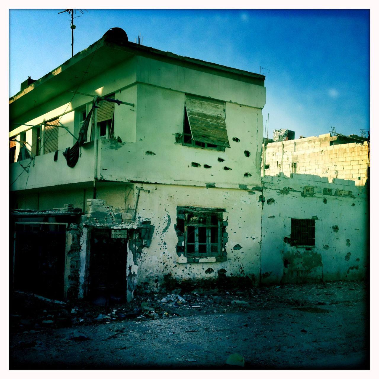 Bullet-scarred walls are pictured in Baba Amr, Homs. 