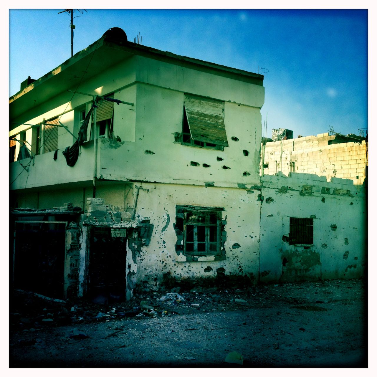 Bullet-scarred walls are pictured in Baba Amr, Homs.