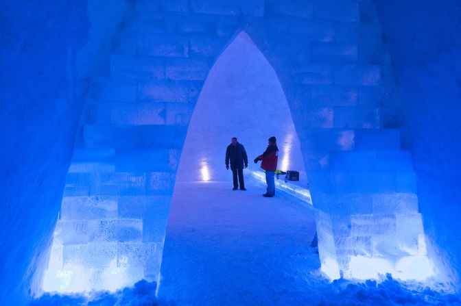 Two men inside the snow church.