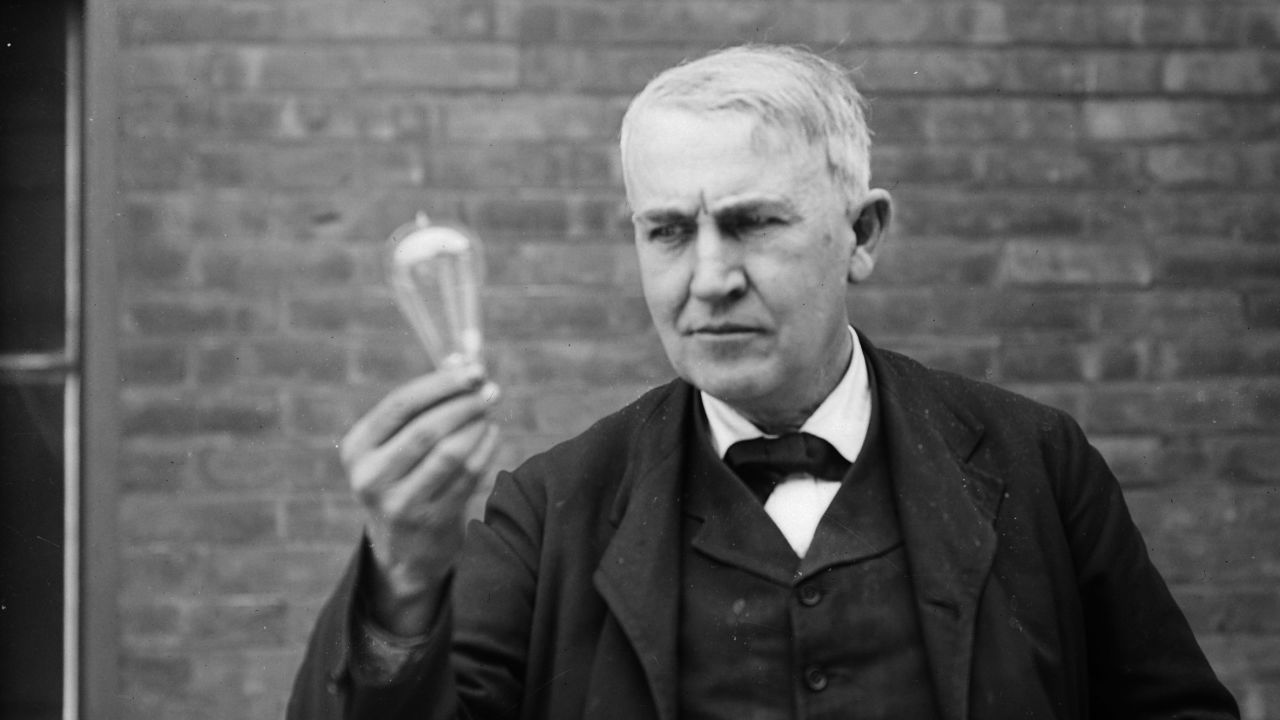 Inventor and physicist Thomas Edison (1847 - 1931) looking at a lightbulb (Photo by Nathan Lazarnick/George Eastman House/Getty Images) 