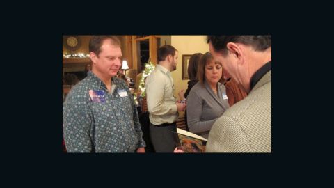 Aaron Rupp, meeting Rick Santorum for the ninth time, gets his book signed at Mitchell's party.