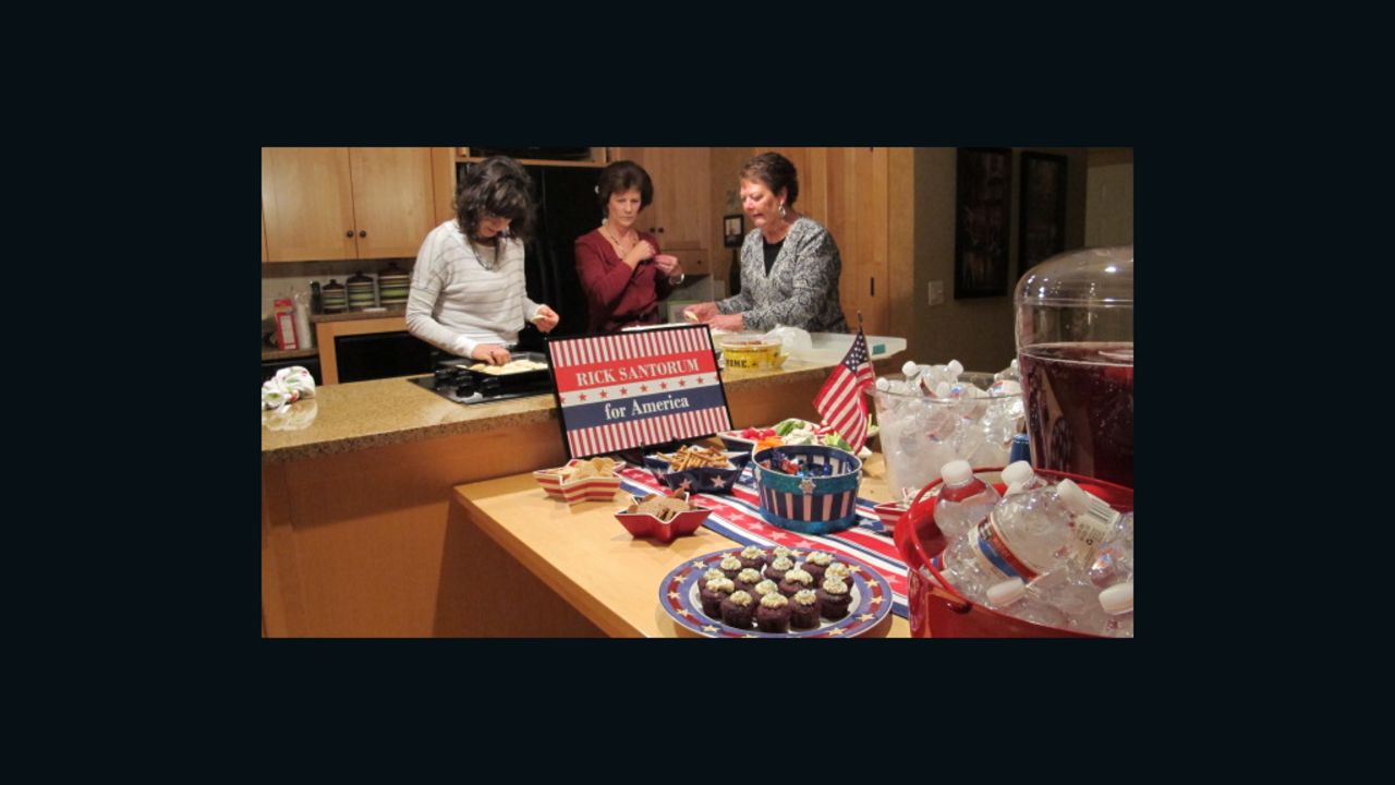 Denise Mitchell, center, hosts a party at her house for friends and neighbors to hear Santorum speak in Robins, Iowa.