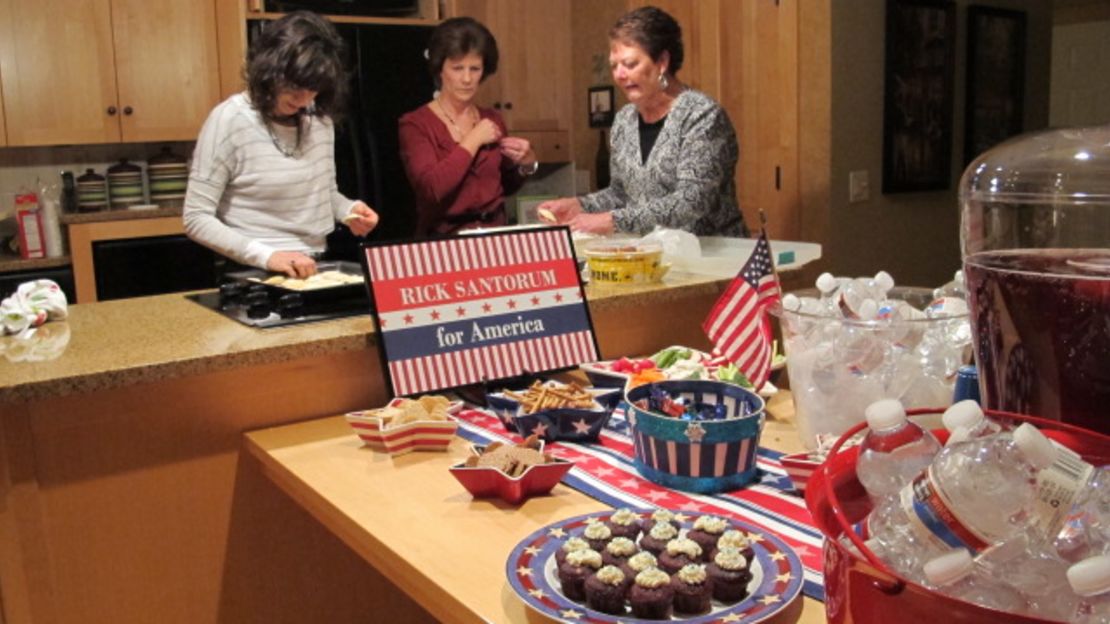 Denise Mitchell, center, hosts a party at her house for friends and neighbors to hear Santorum speak in Robins, Iowa.