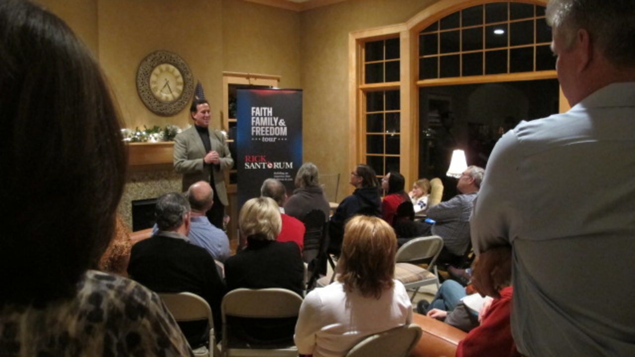 Santorum speaks in the Mitchell living room. The contender came with no entourage and no campaign bus.
