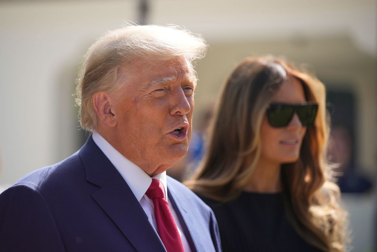 Former President Donald Trump talks to the media with Melania Trump, after voting on November 8, in Palm Beach, Florida.