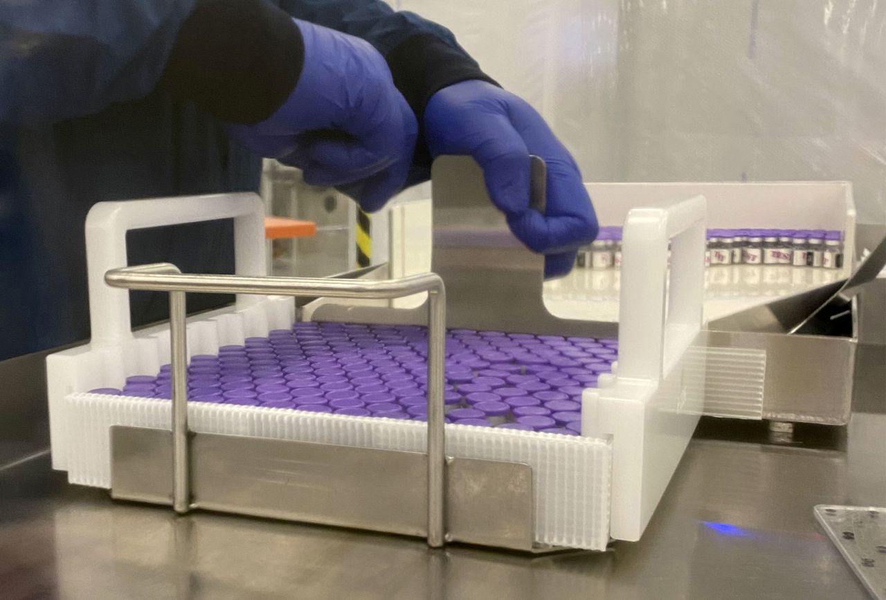 An employee handles vials of coronavirus vaccine at the Pfizer manufacturing facility in Kalamazoo, Michigan.