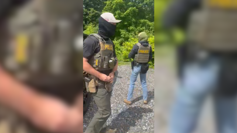112455-masked-agents-arrest-gardener-horizontal-thumb.png