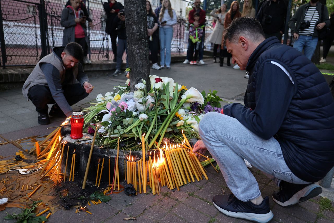 People light candles near a school after a shooting happened at Vladislav Ribnikar elementary school in Belgrade earlier Wednesday.