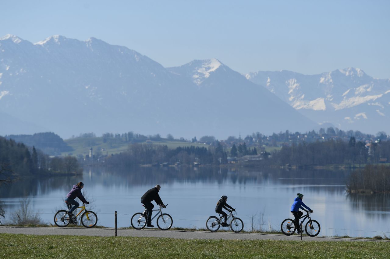 Cyclists pass Lake Riegsee in Bavaria, Germany, on April 5.