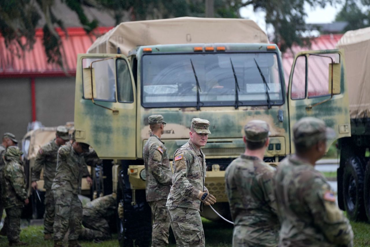 Members of the National Guard prepare their equipment in Mayo, Florida, as they wait for instructions on where to respond on Wednesday.